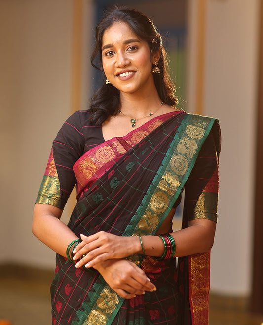 Black Chettinad Cotton Saree Features Butta Enclosed Checks, a Contrast Temple Annam-Peacock Ganga-Jamuna Border, and a Matching Blouse