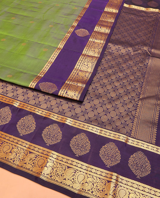 Green Vasundhara Lite Silk Mix Saree Ornamented with Zari Buttas, Complemented with a Contrast Border of Muthu, Banaras, Rudraksham, and Mayil Designs, Pallu Adorned with Rudraksham Designs, and a Contrast Blouse
