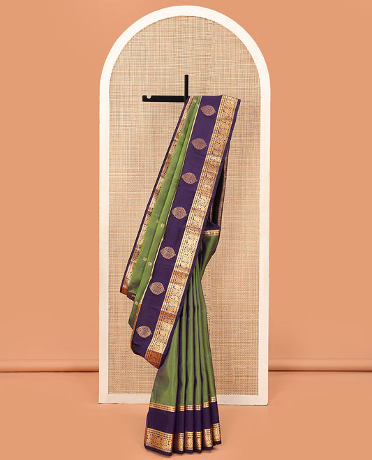 Green Vasundhara Lite Silk Mix Saree Ornamented with Zari Buttas, Complemented with a Contrast Border of Muthu, Banaras, Rudraksham, and Mayil Designs, Pallu Adorned with Rudraksham Designs, and a Contrast Blouse