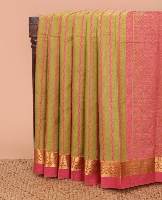Green zig-zag striped kanchi cotton saree, contrast leaf creeper zari border, and jaal pallu
