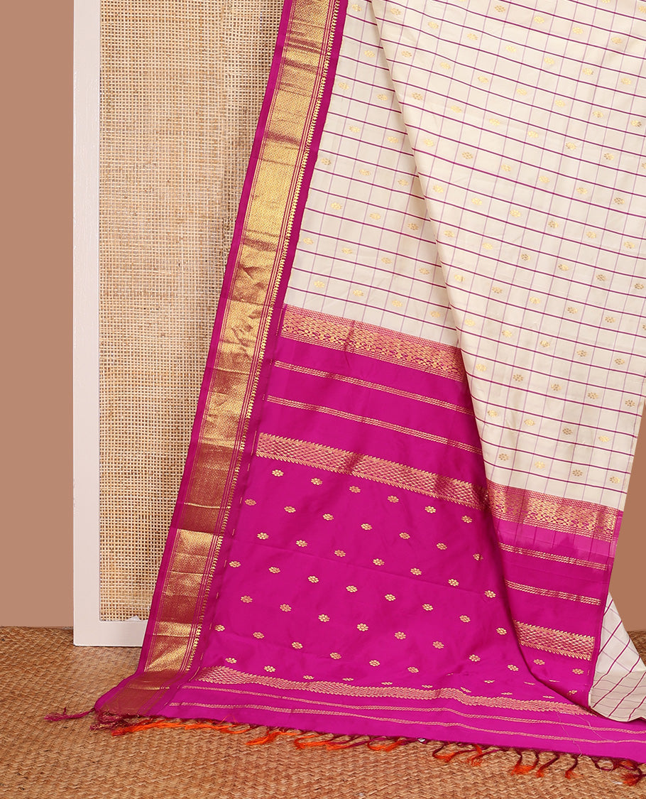 Cream kamalam zari buttas with checked Kanchipuram silk saree, contrast korvai border of thilakam mokku, banaras, and mayil kann designs, and zari design pallu