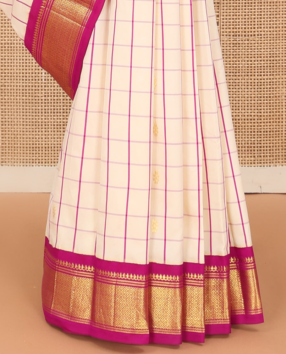 Cream kamalam zari buttas with checked Kanchipuram silk saree, contrast korvai border of thilakam mokku, banaras, and mayil kann designs, and zari design pallu