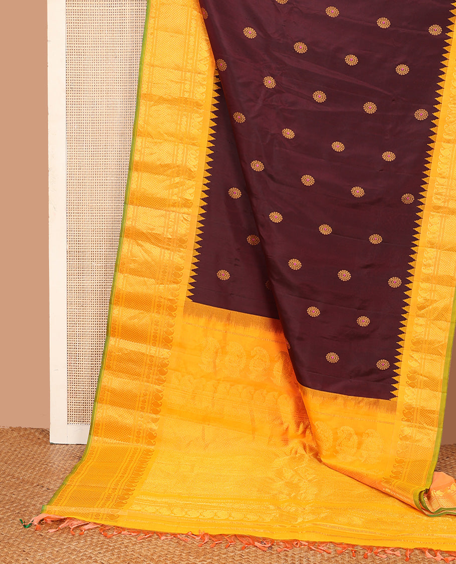 Maroon meena chakram buttas gadwal silk saree, contrast thazampoo rekku border of manga mokku, kathir, laddu kamalam, and mayil kann designs