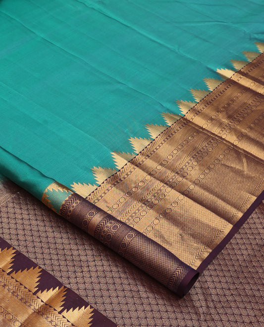 Green plain Kanchipuram silk saree, contrast thazampoo rekku rettai pettu border of rekku, kathir, diamond, poun, and mayil kann and jaal pallu