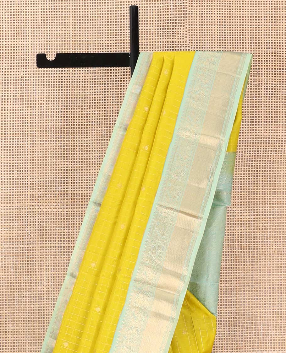 Mustard zari design silk saree, contrast border of thilakam, kathir, and mayil designs, and then kuli kann style oven pallu