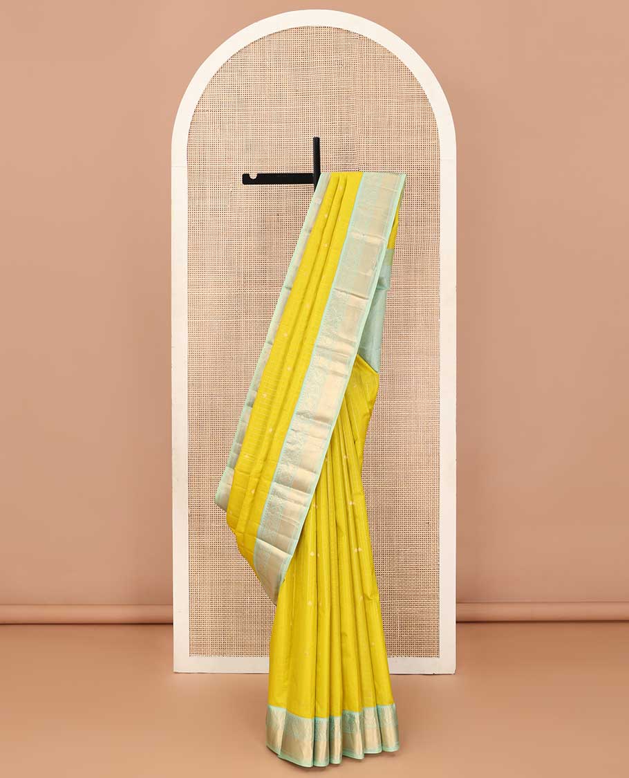 Mustard zari design silk saree, contrast border of thilakam, kathir, and mayil designs, and then kuli kann style oven pallu