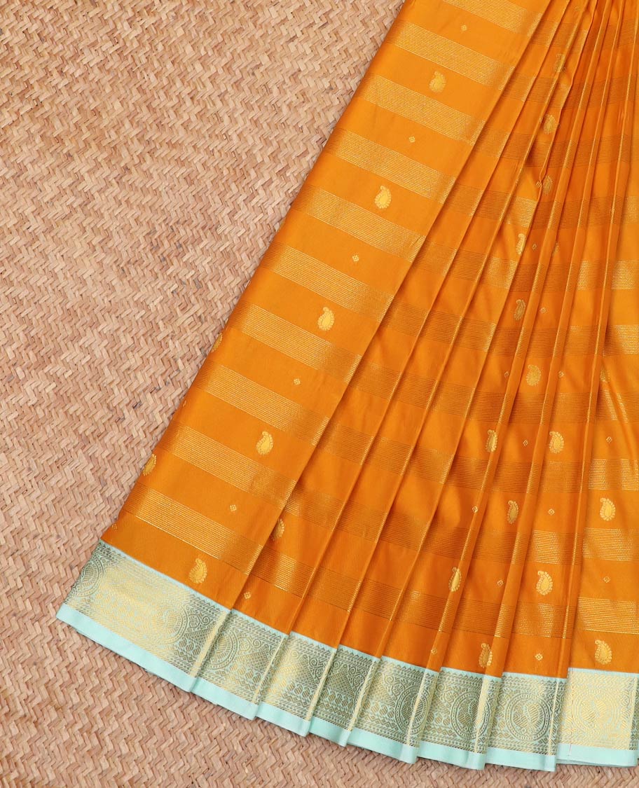 Orange Budget Silk Saree Bedecked with Zari Stripes and Paisley Buttas, Complemented by a Contrast Border of Traditional Zari Designs, Subtly Designed Pallu of Stripes, and Paired with a Contrast Blouse