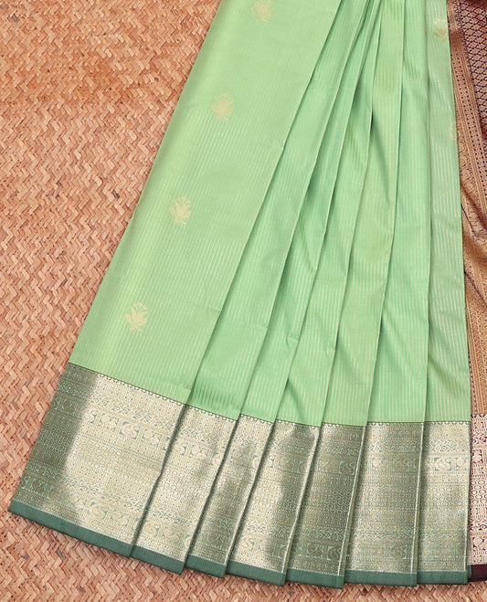 Pista Green Budget Silk Saree Subtly Sparkled With Zari Buttas and Stripes All Over Its Body, Complemented by Contrast Traditional Zari Designs Woven Border, Grandly Decked Up Pallu and Paired with a Contrast Blouse