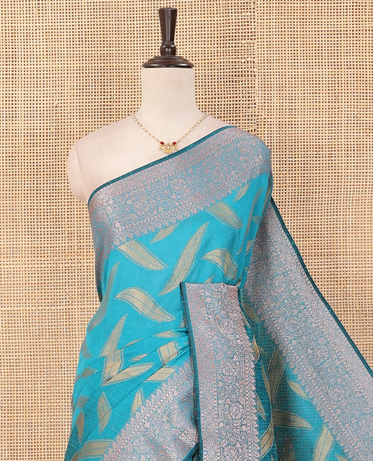Blue leaf buttas dupion saree, traditional border of floral creeper designs, and pallu of multi-colored thread stripes