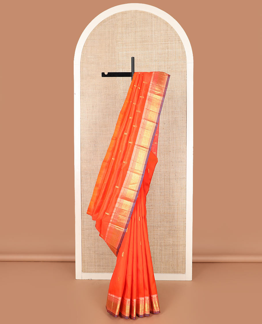 Orange zari buttas Kanchipuram silk saree, contrast one-sided border of paneer sombu, banaras, muthu, and jaal designs, and  zari design pallu
