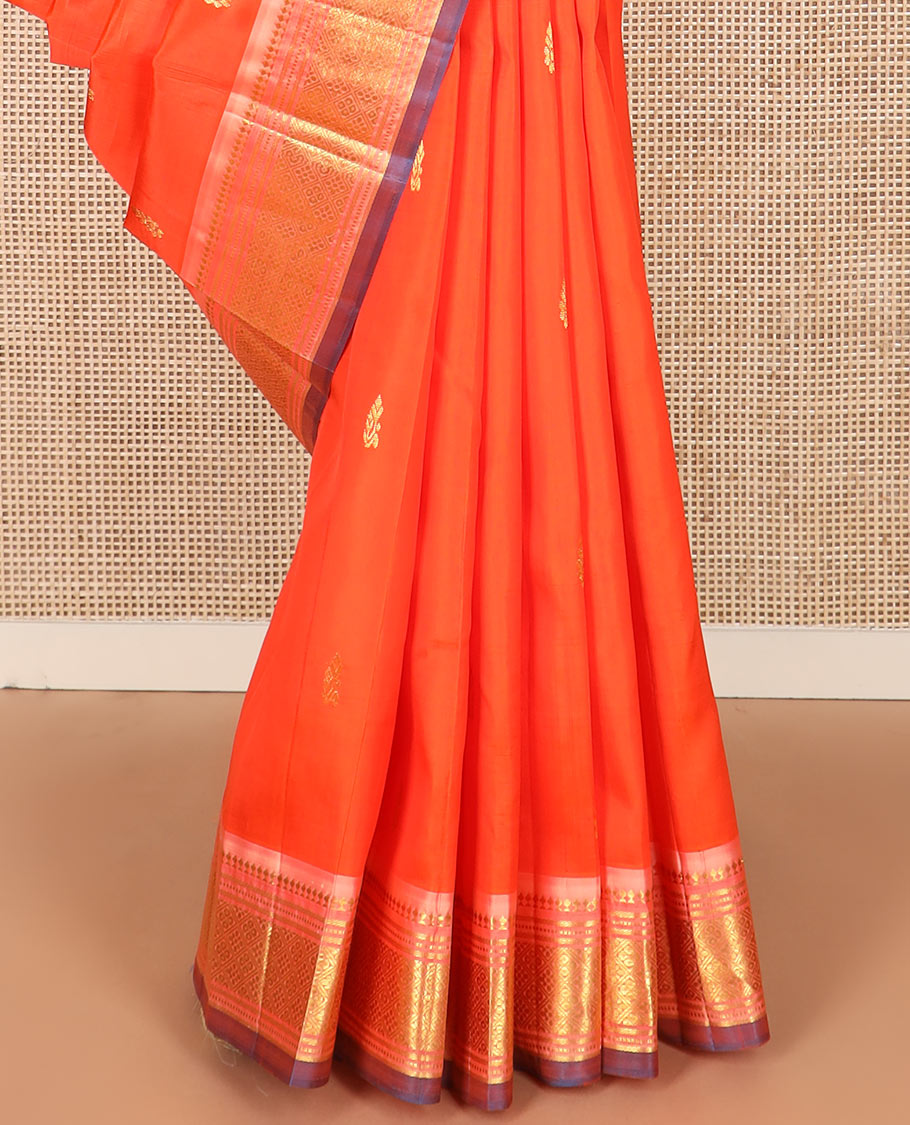 Orange zari buttas Kanchipuram silk saree, contrast one-sided border of paneer sombu, banaras, muthu, and jaal designs, and  zari design pallu