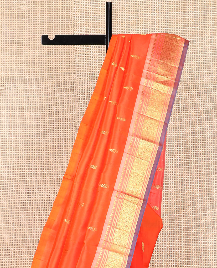 Orange zari buttas Kanchipuram silk saree, contrast one-sided border of paneer sombu, banaras, muthu, and jaal designs, and  zari design pallu