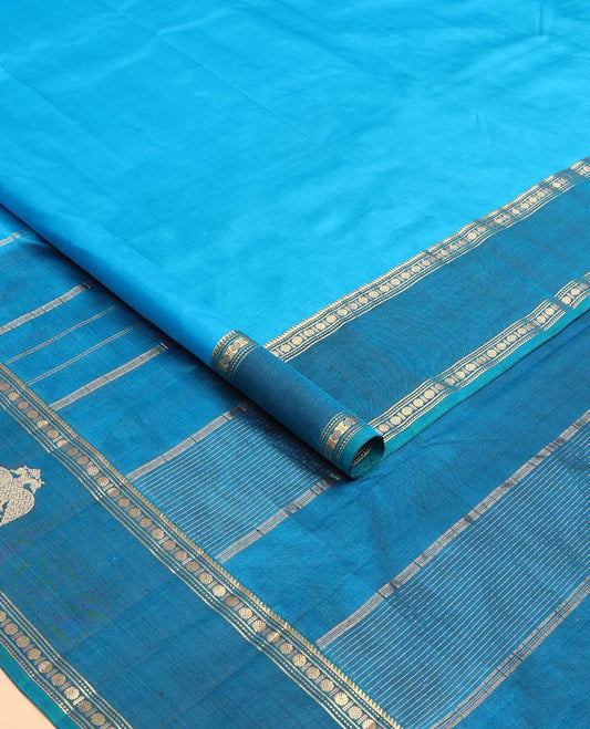 Blue plain Kanchipuram silk saree, contrast border of rekku, muthu, rudraksham and iruthalai pakshi motifs, and zari striped pallu