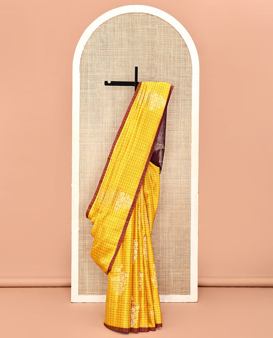Yellow Mayuri Soft Silk Saree, Richly Detailed with Checks and Buttas All Over Its Body, Subtle Contrast Piping Border, Majestically Detailed Pallu of Leaf Designs, and Paired with a Contrast Blouse