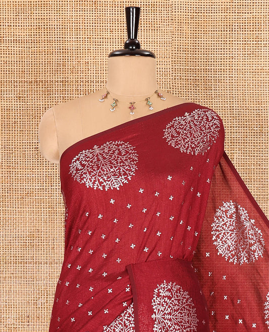 Maroon plus buttas woven Vichitra silk saree, kalpavriksha tree motifs woven on its border, self-pallu, and no blouse