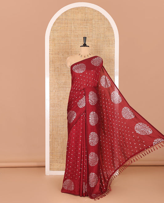 Maroon plus buttas woven Vichitra silk saree, kalpavriksha tree motifs woven on its border, self-pallu, and no blouse