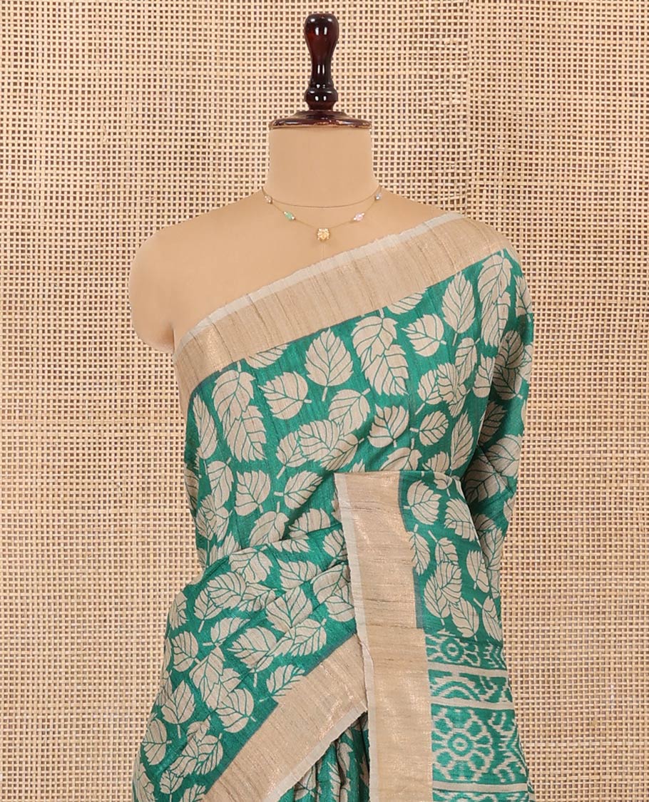 Green Tussar Silk Saree Accentuated with Leaf Motifs Printed All Over Its Body, Featuring a Contrast Border, Complemented by Contrast Pallu of Ikkat-Style Print, and Paired with a Matching Blouse