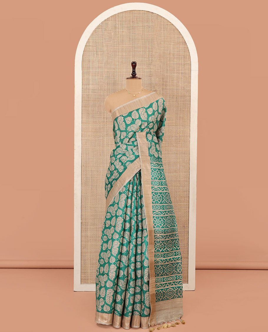 Green Tussar Silk Saree Accentuated with Leaf Motifs Printed All Over Its Body, Featuring a Contrast Border, Complemented by Contrast Pallu of Ikkat-Style Print, and Paired with a Matching Blouse
