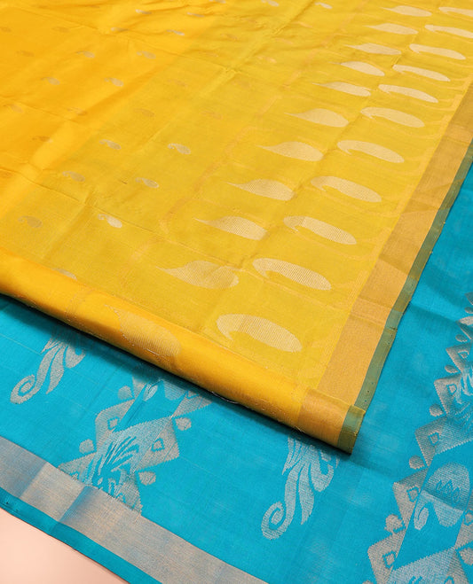 Yellow Uppada Silk Saree Gracefully Embellished with Zari Buttas and Paisley Buttas, Subtle Bavanji Border, Complemented by Contrast Pallu of Peacock Designs, and Paired with a Contrast Blouse