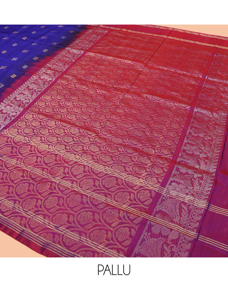 Blue Uppada Silk Saree Enlivened With Zari Buttas, Captivating Contrast Border Featuring Zari Stripes And Peacock Motifs, Pallu Depicting Rose Flower-Enclosed Mughal-Style Arches, And Paired With A Contrast Blouse