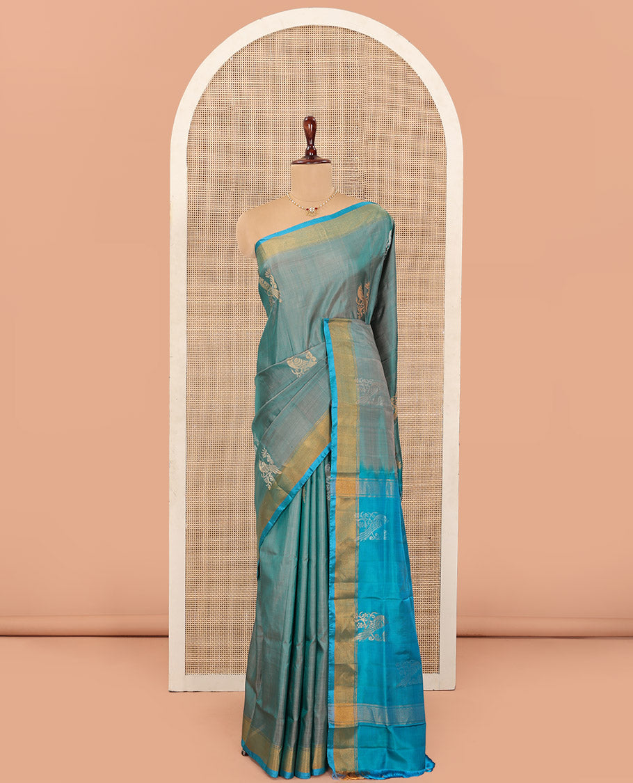 Blue Uppada Silk Saree Accentuated with Parrot Zari Buttas, Complemented by Bavanji Border, Contrast Pallu Steeped with Parrot Zari Designs, and Paired with a Contrast Blouse