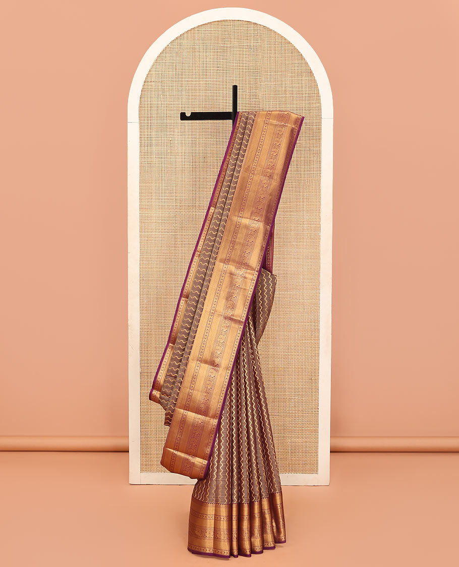 Brown Vasundhara Lite Silk Mix Saree Showcasing Zig-Zag Stripes Across the Body, Enhanced by a Contrast Border Adorned with Rekku, Puli Nagam, Laddu Kamalam, and Mayil Motifs, Complemented with a Zari-Woven Pallu and a Contrast Blouse