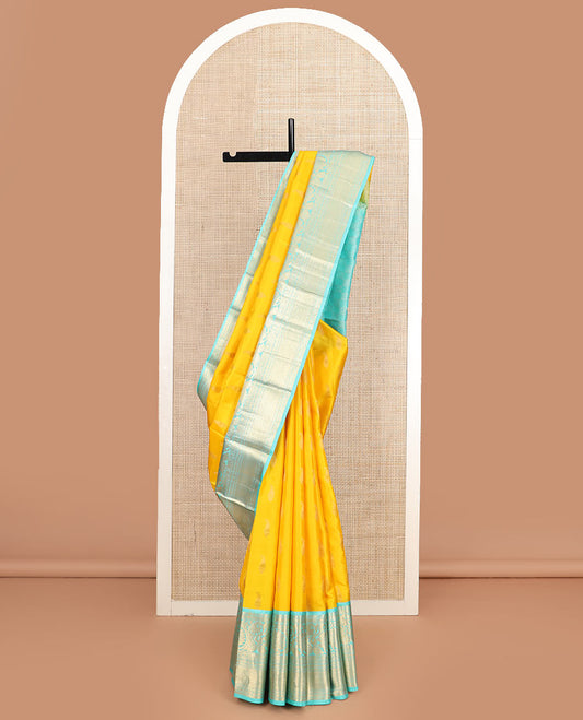 Yellow zari buttas silk saree, contrast border of thilakam, poun, kodi visiry, mayil kann, neli, and kathir designs, and butta enclosed checked pallu