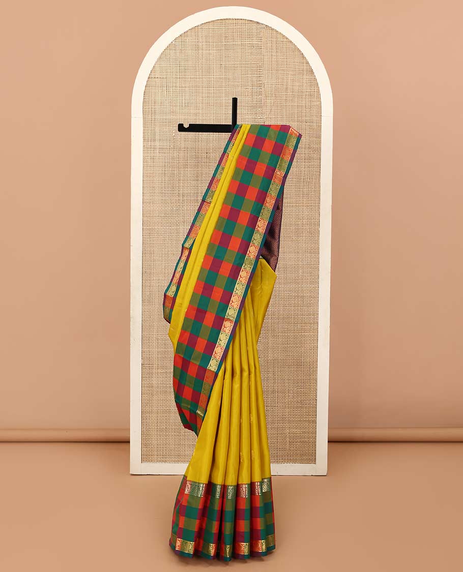 Yellow zari buttas Kanchipuram silk saree, contrast multi-color checked border of jadai nagam, and mayil designs, and contrast zari-rich jaal pallu