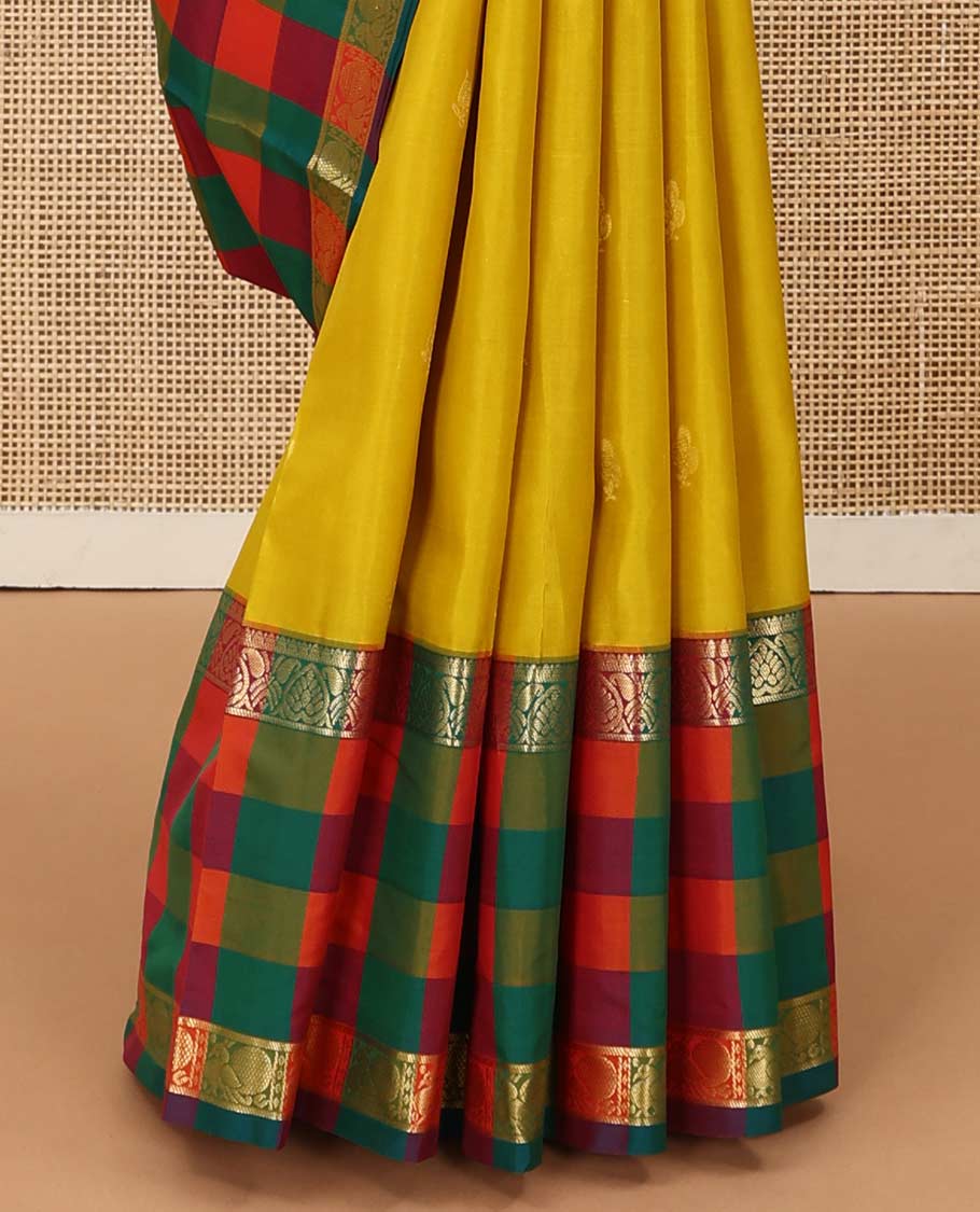 Yellow zari buttas Kanchipuram silk saree, contrast multi-color checked border of jadai nagam, and mayil designs, and contrast zari-rich jaal pallu