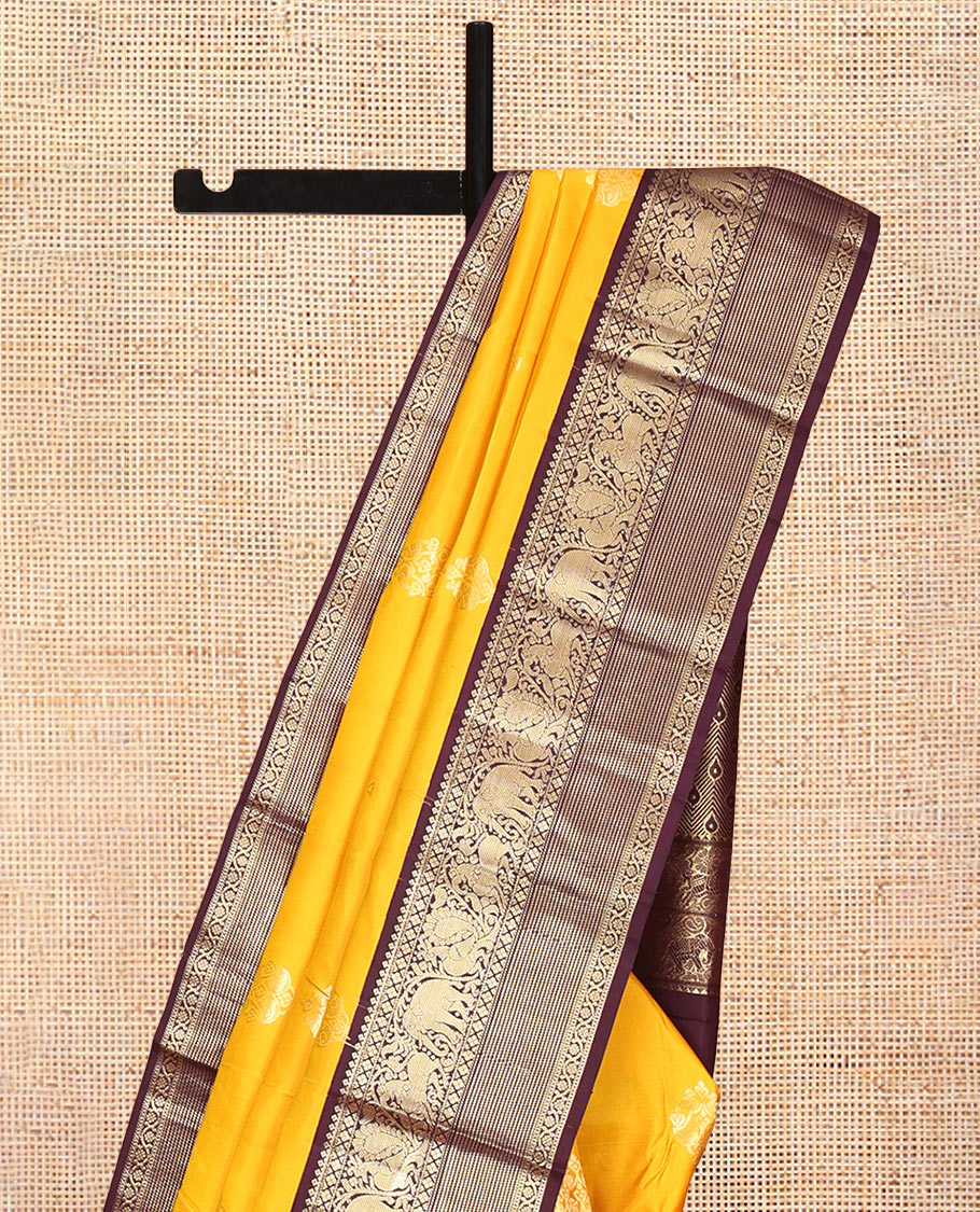 Yellow Vasundhara Silk Saree, Richly Detailed with Zari Buttas, Contrast Border of Thilakam Mokku, Mayil Kann, Yaali, Yaanai, Mayil, and Kodi Visiry, Grand Pallu, and a Contrast Blouse