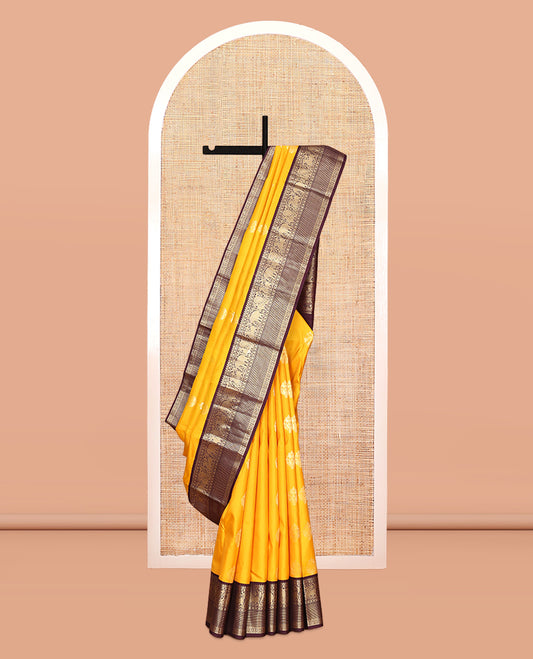 Yellow Vasundhara Silk Saree, Richly Detailed with Zari Buttas, Contrast Border of Thilakam Mokku, Mayil Kann, Yaali, Yaanai, Mayil, and Kodi Visiry, Grand Pallu, and a Contrast Blouse