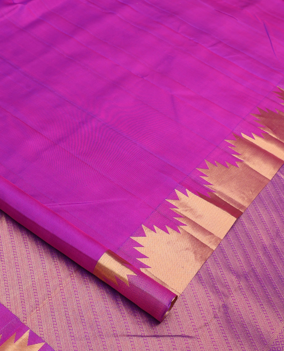 Rani pink plain Kanchipuram silk saree, thazampoo rekku zari border, and diagonally woven geometric patterned pallu