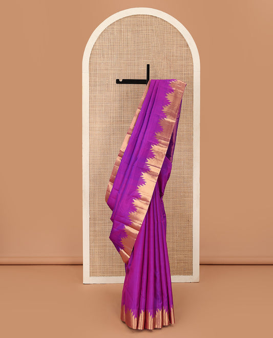 Rani pink plain Kanchipuram silk saree, thazampoo rekku zari border, and diagonally woven geometric patterned pallu