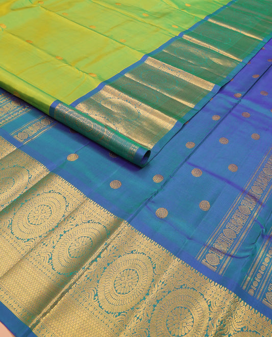 Green chakram buttas Kanchipuram silk saree, contrast border of muthu, rudraksham,  poo chakram, and mayil kann designs, and chakram motifs pallu