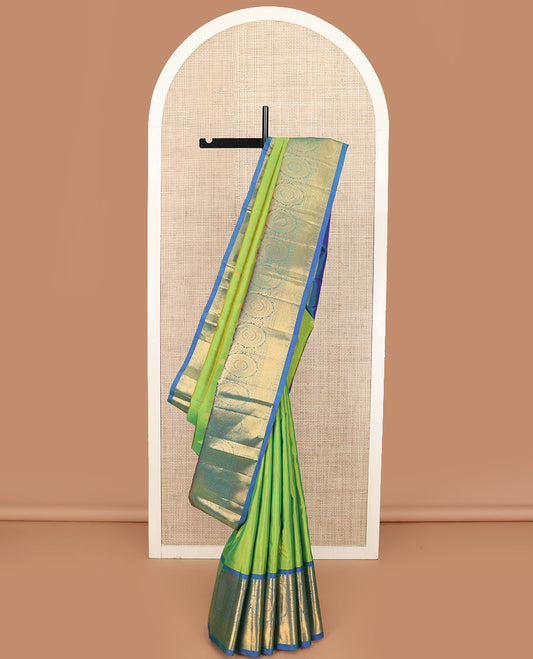 Green chakram buttas Kanchipuram silk saree, contrast border of muthu, rudraksham,  poo chakram, and mayil kann designs, and chakram motifs pallu