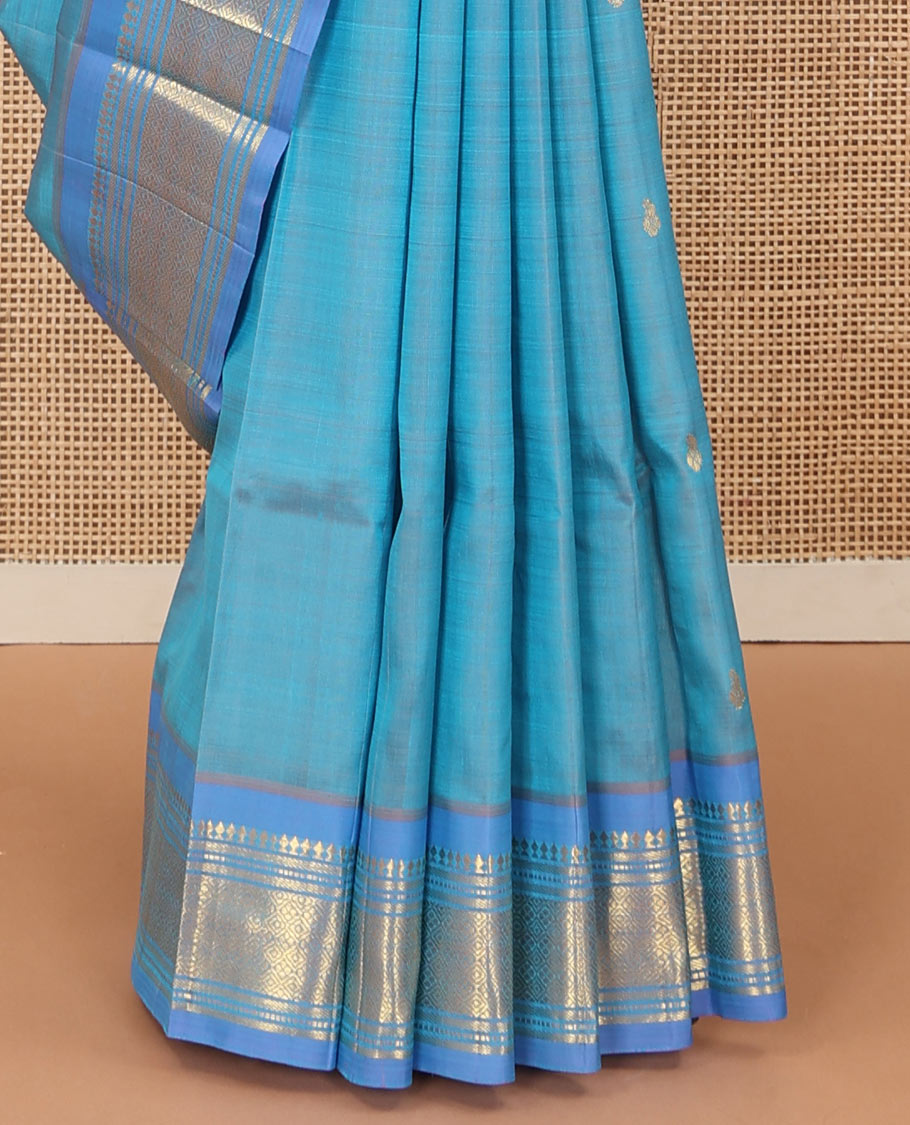 Blue zari buttas Kanchipuram silk saree, contrast one-sided border of panner sombu, muthu, banaras, and jaal, and zari woven pallu