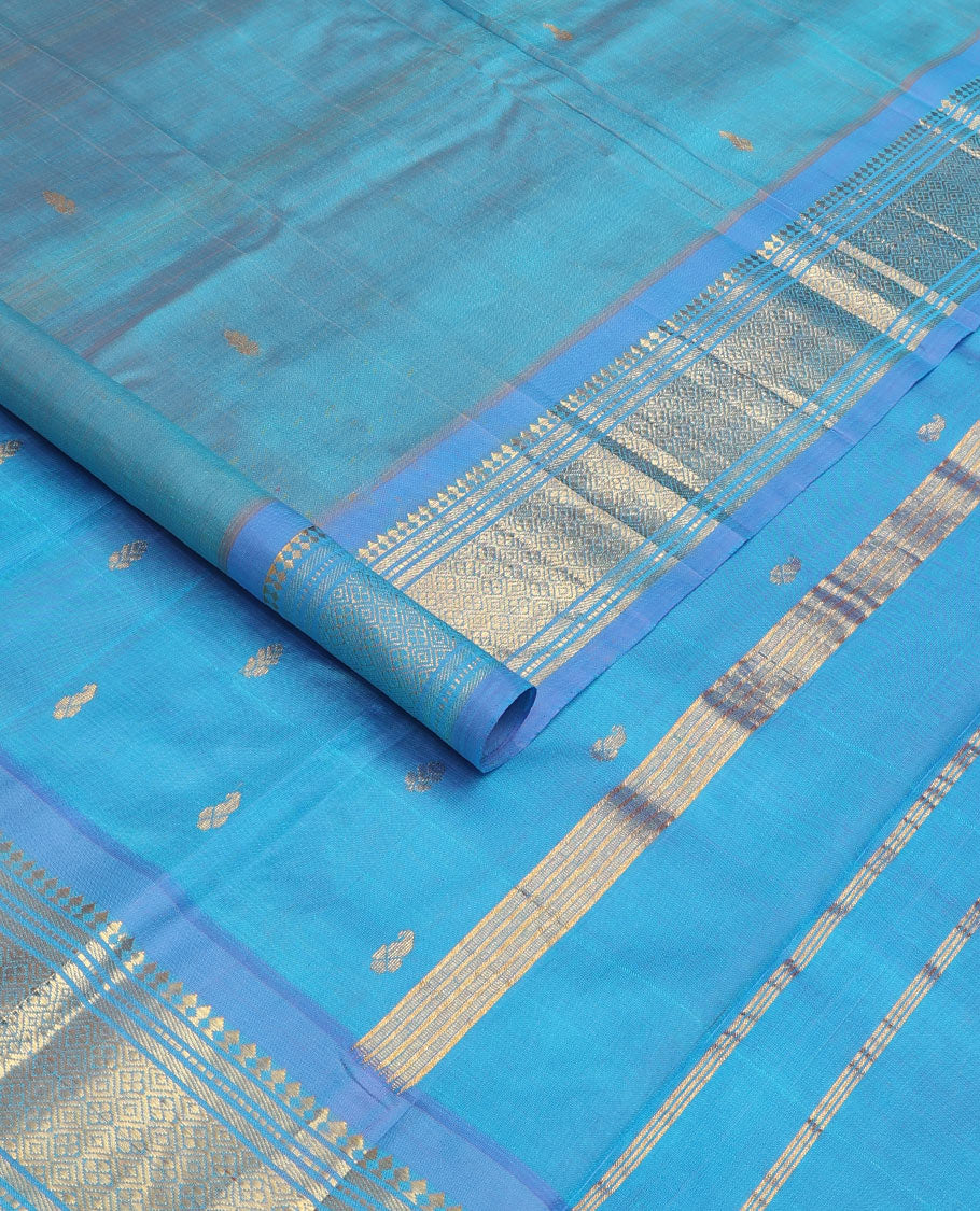 Blue zari buttas Kanchipuram silk saree, contrast one-sided border of panner sombu, muthu, banaras, and jaal, and zari woven pallu