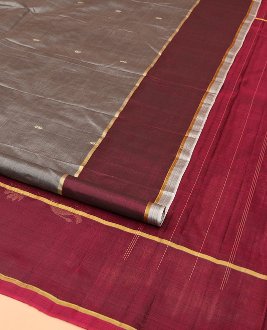 Grey Kanchipuram Silk Saree, Delicately Woven with Buttas All Over Its Body, Complemented by a Contrast Border of Jhumka Designs, Pallu Features Yaanai Designs, and Paired with a Contrast Blouse