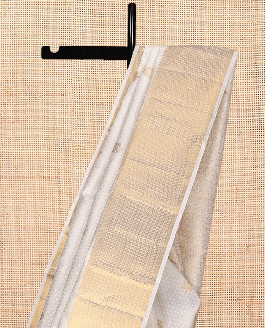 Cream Embossed Parambara Silk Saree, Enthralled with Zari Buttas, a Zari Border of Thilakam Mokku, and Vanki Designs, Grand Pallu, and Matching Blouse