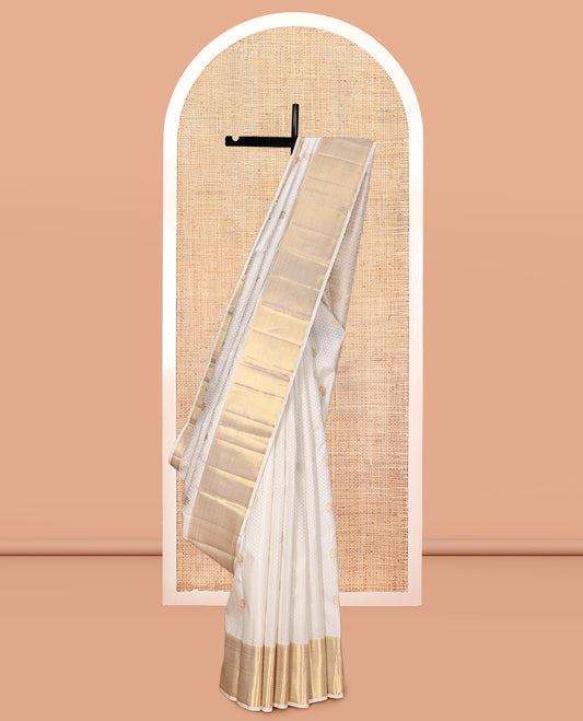 Cream Embossed Parambara Silk Saree, Enthralled with Zari Buttas, a Zari Border of Thilakam Mokku, and Vanki Designs, Grand Pallu, and Matching Blouse
