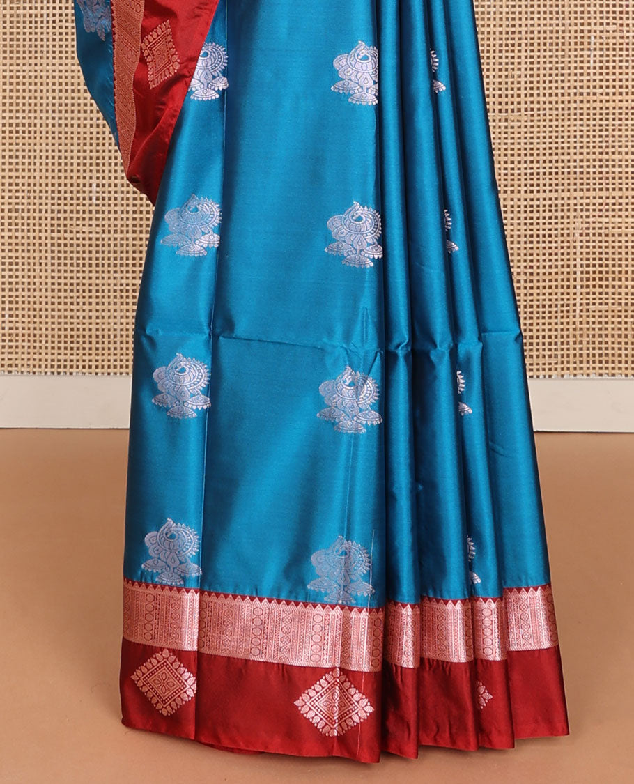 Blue semi-soft silk saree with zari buttas, contrast diamond design border & intricate pallu