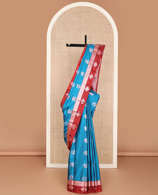 Blue semi-soft silk saree with zari buttas, contrast diamond design border & intricate pallu