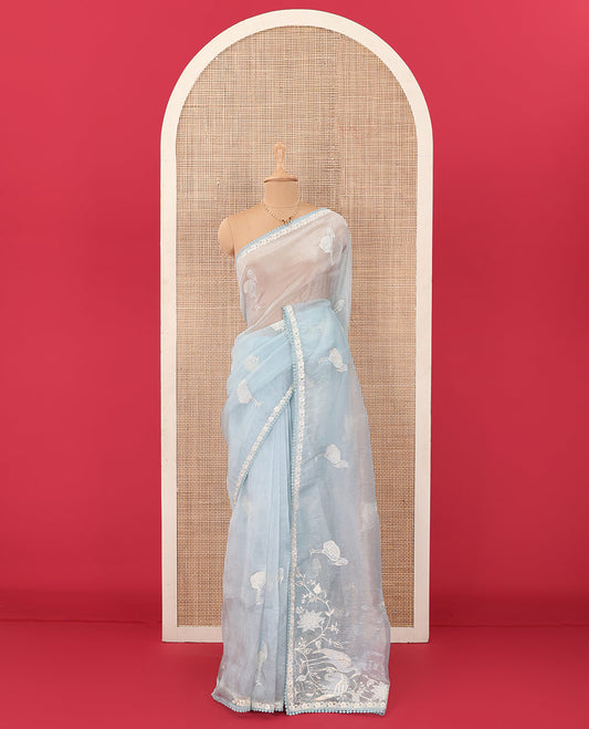 Powder blue flamingo motifs thread embroidered tussar saree, pom-pom lace border, and flamingo motifs thread embroidered pallu