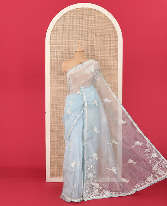 Powder blue flamingo motifs thread embroidered tussar saree, pom-pom lace border, and flamingo motifs thread embroidered pallu