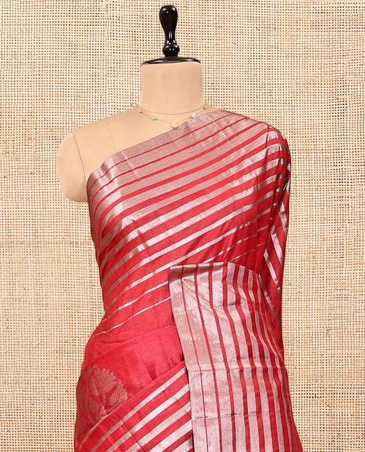 Borderless Red Tussar Silk Saree, Gracefully Embellished with Zari Stripes and Floral Buttas, Striped Pallu, and a Matching Blouse