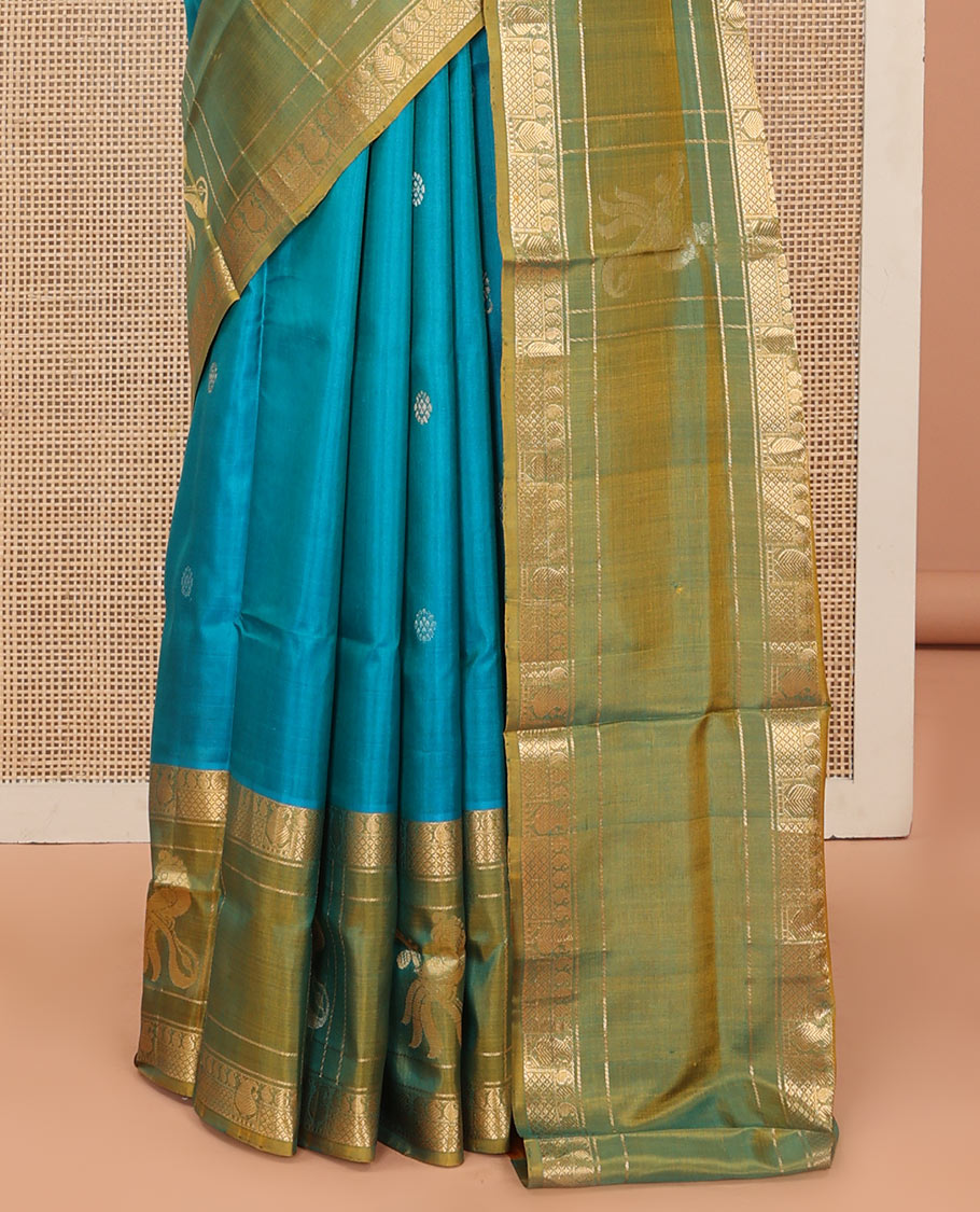 Blue Uppada Silk Saree Graced with Zari Buttas, Complemented by a Contrast Traditional Zari Border of Peacock Veena Designs, Contrast Pallu of Floral Jaal Designs, and Paired with a Contrast Blouse