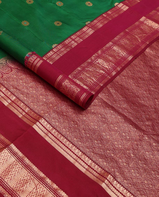 Green kamalam meena buttas silksaree, contrast rettai pettu border of thilakam,neli,mayil kann & puli nagam & intricate pallu