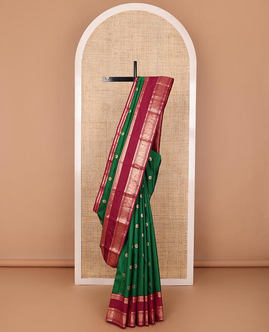 Green kamalam meena buttas silksaree, contrast rettai pettu border of thilakam,neli,mayil kann & puli nagam & intricate pallu