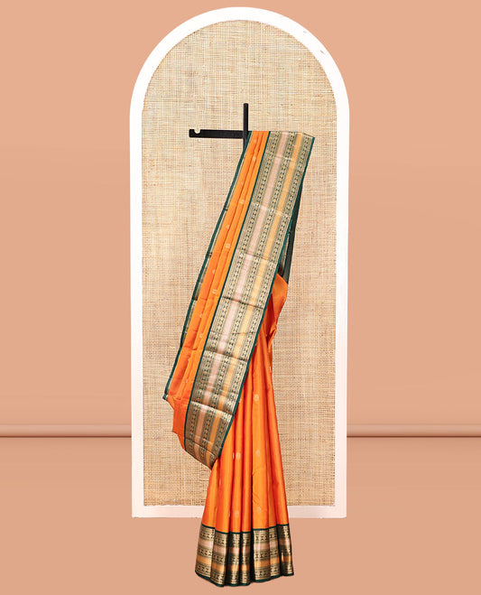 Orange Vasundhara Silk Saree, Woven with Zari Buttas, Contrast Border of Thilakam Mokku, Neli, Muthu, Kuyil Kann, Rudraksham, and Star Vanki, Grand Pallu, and a Contrast Blouse