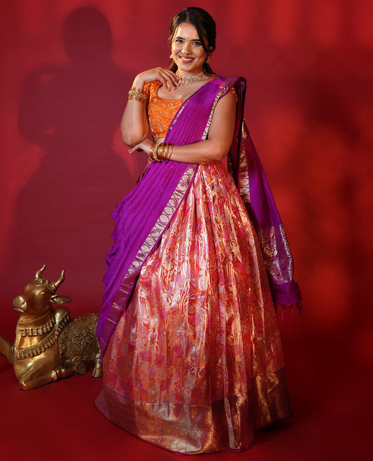 Orange Art Silk Half-Saree, Adorned with a Jacquard Design Stitched Skirt, Complemented by a Contrast Traditional Zari Design Woven Border, Paired with a Blouse, and a Contrast Traditional Zari-Bordered Dhavani